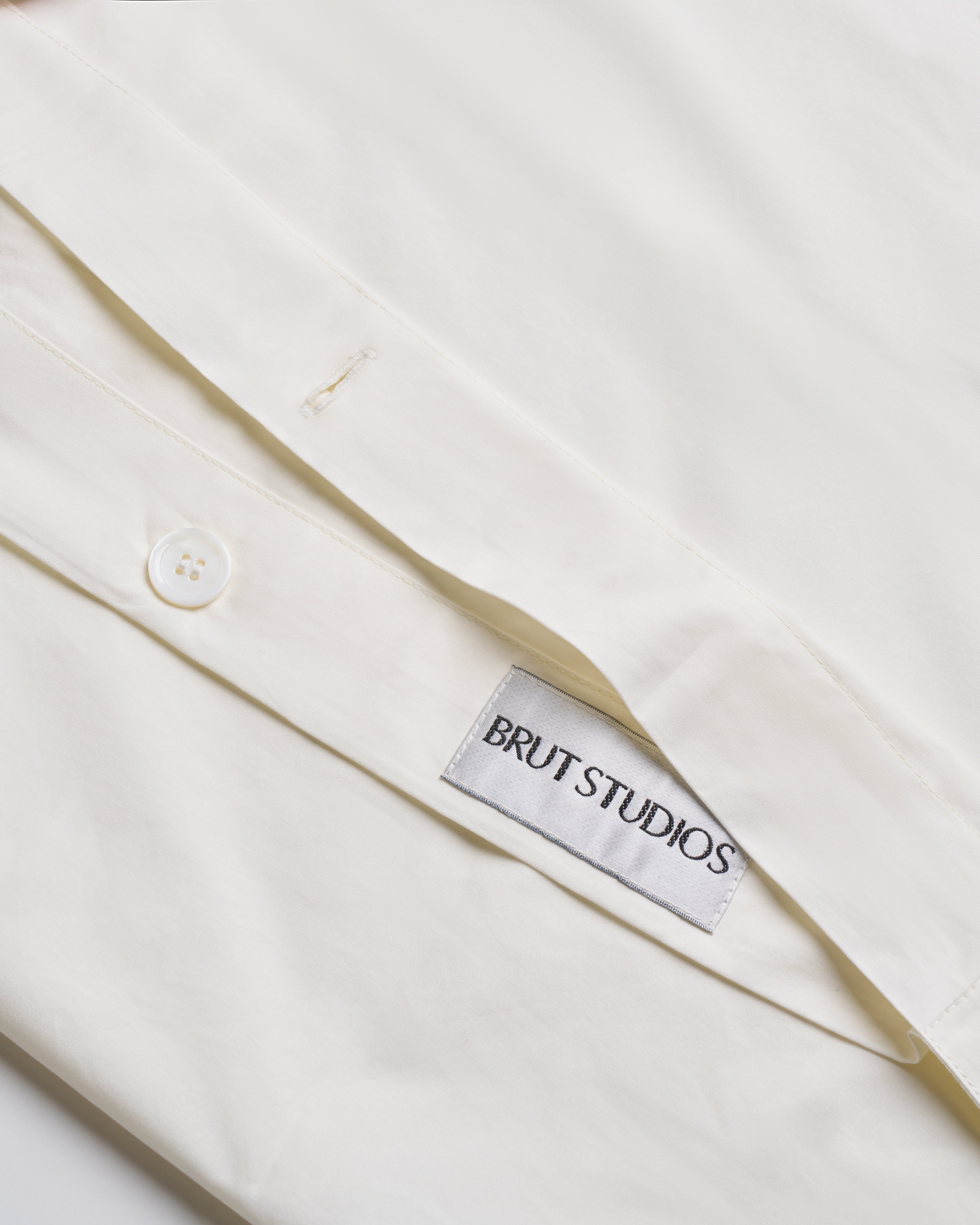 Ashen Stone percale duvet cover, draped on bed, crisp finish