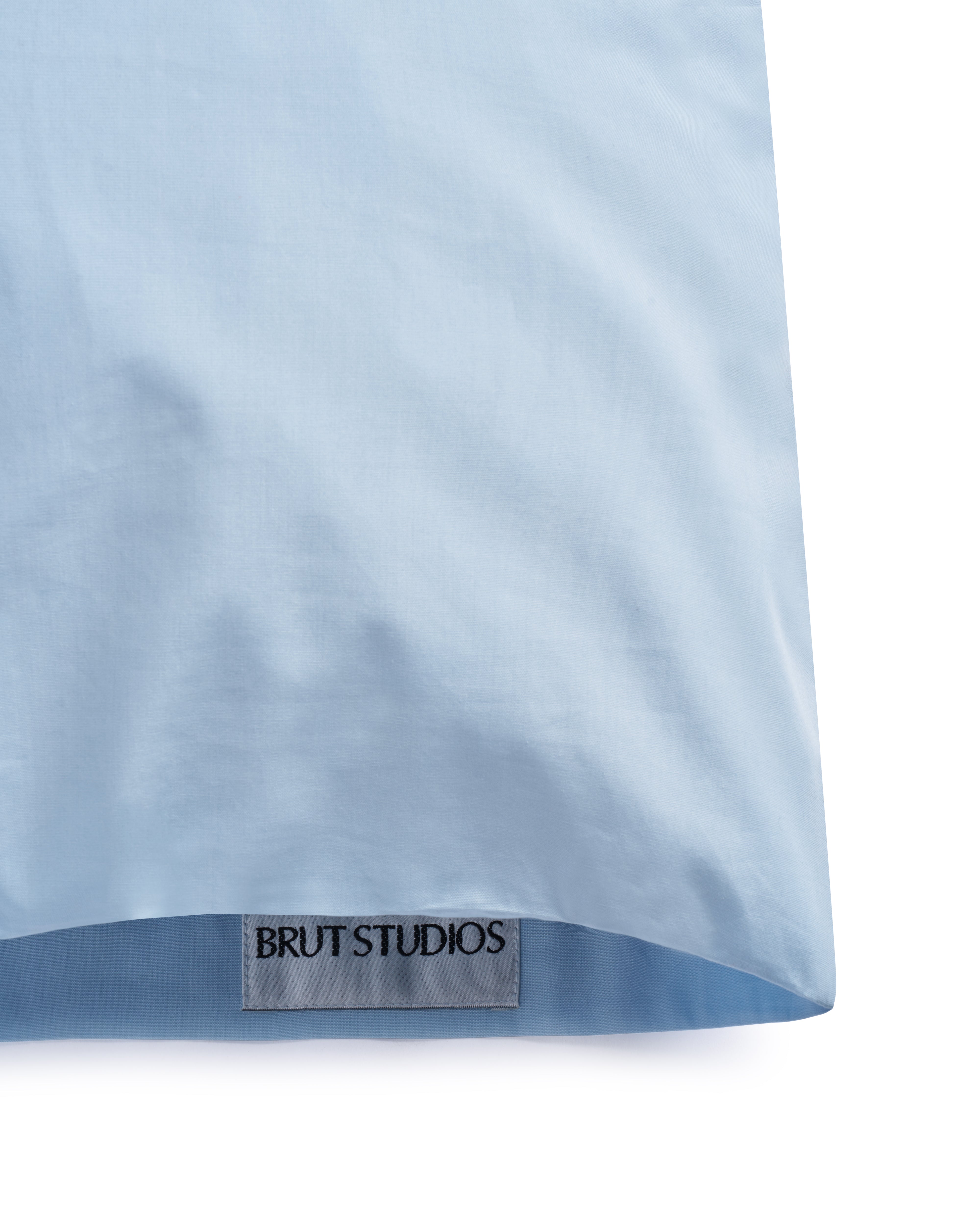 Concrete Blue percale pillowcase, styled on pillow