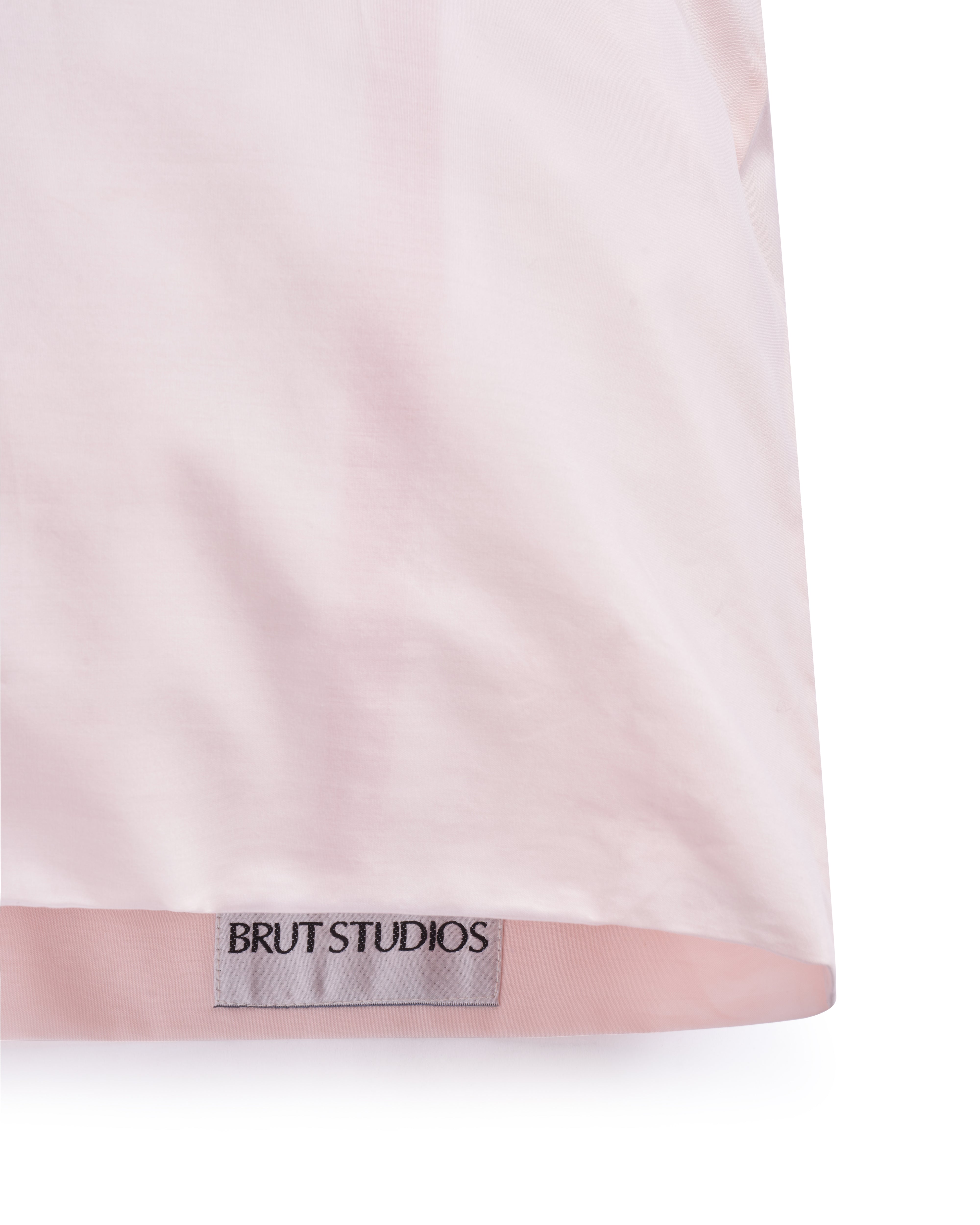 Clay Dust percale pillowcase, styled on pillow