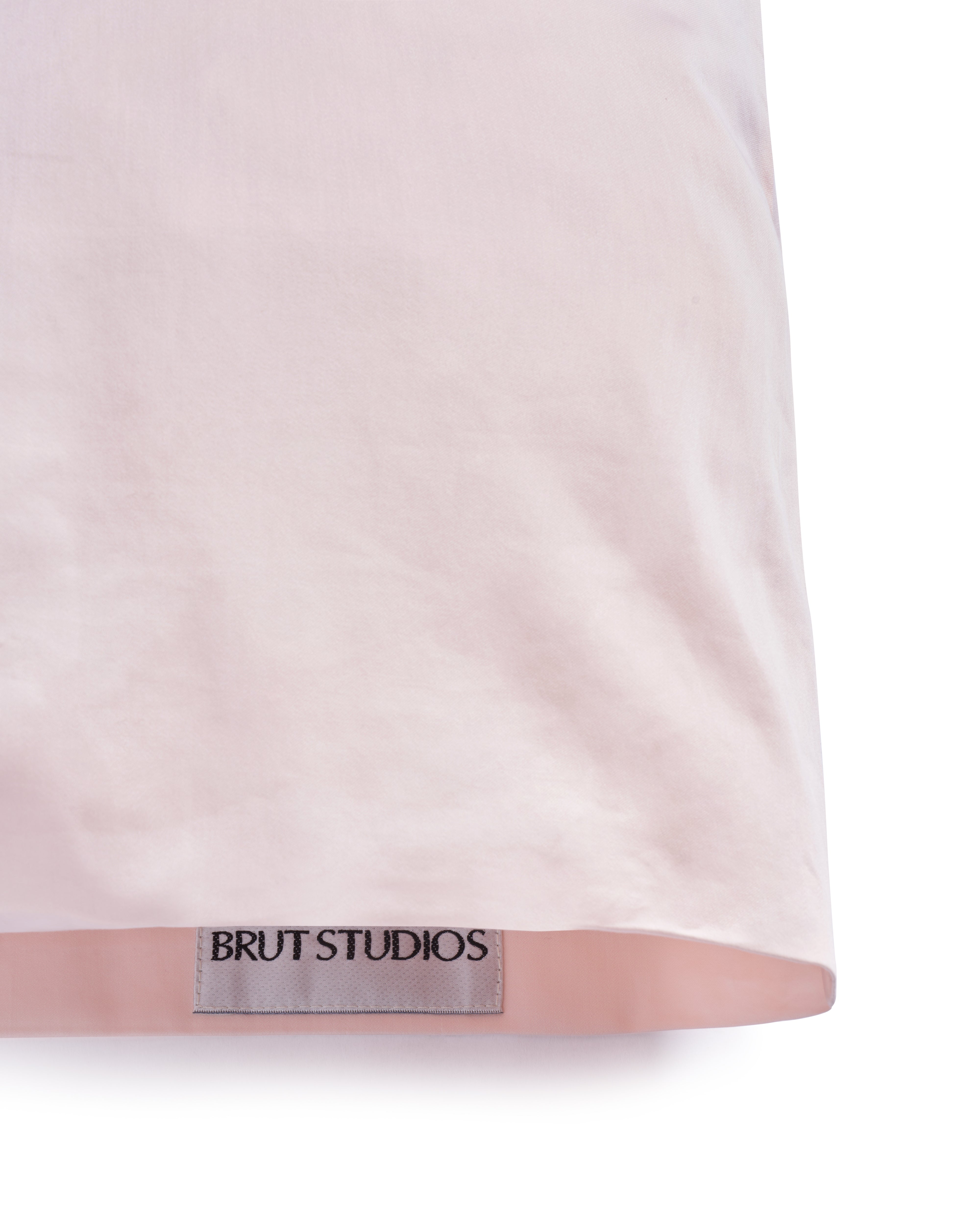 Clay Dust sateen pillowcase, styled on pillow